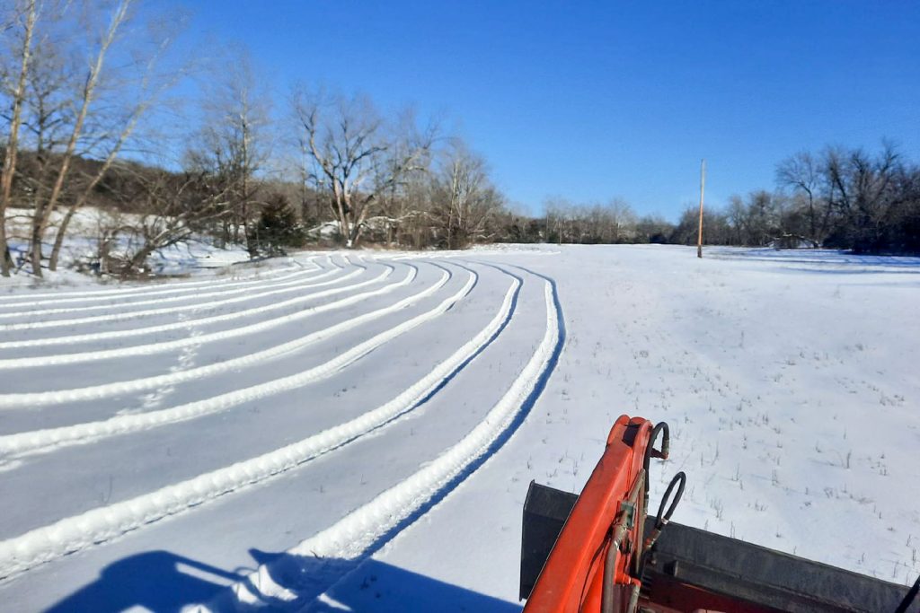 Seedbed preparation by dragging guide, tire tracks in snow, Hamilton Native Outpost
